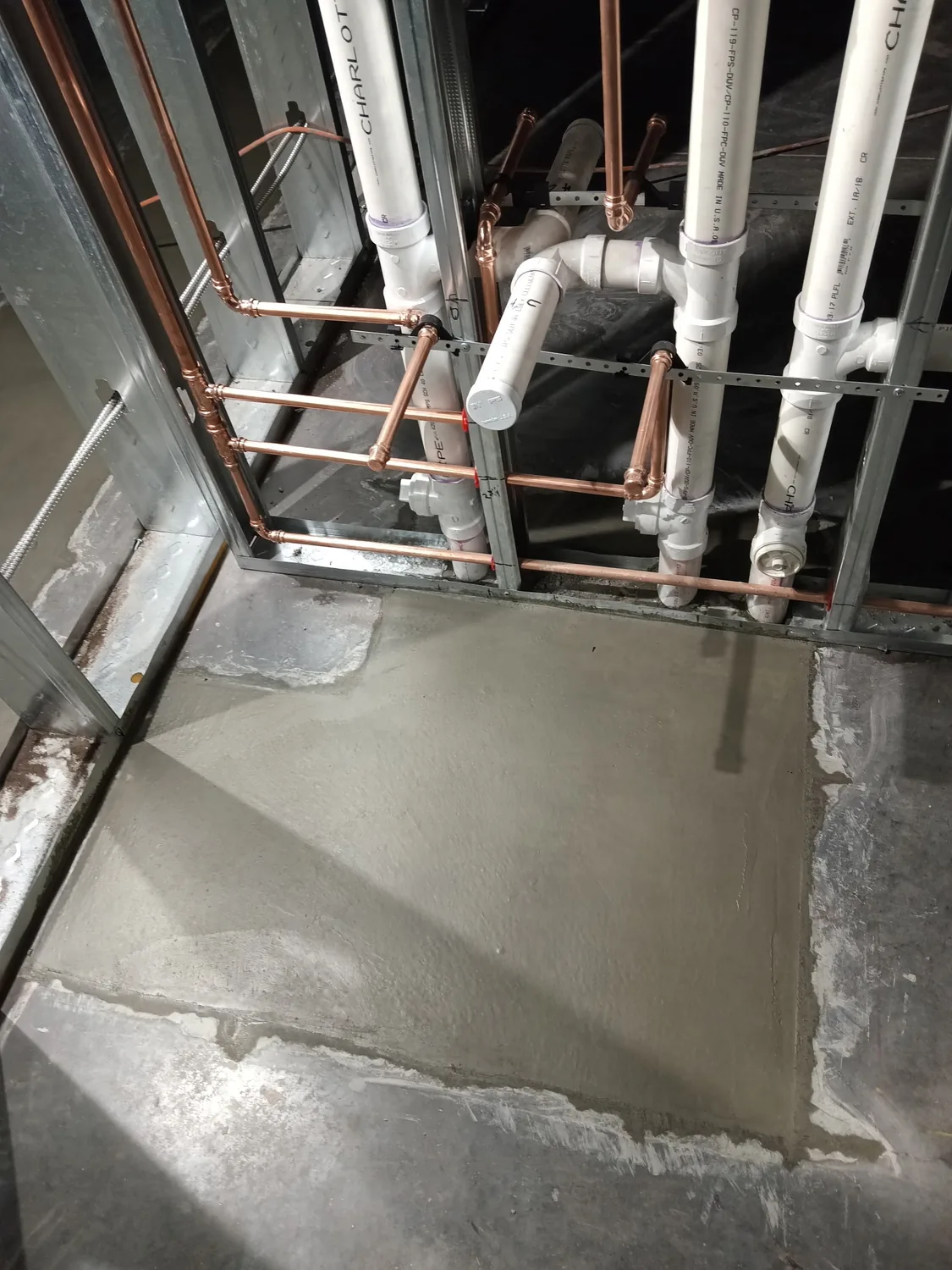 Night commercial concrete pour and finishing under work lights by Billy's Concrete